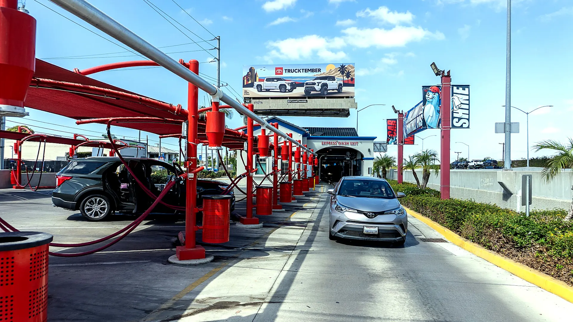 Free vacuum bay at Seal Shine Express Car Wash with a customer driving out of the express wash exit